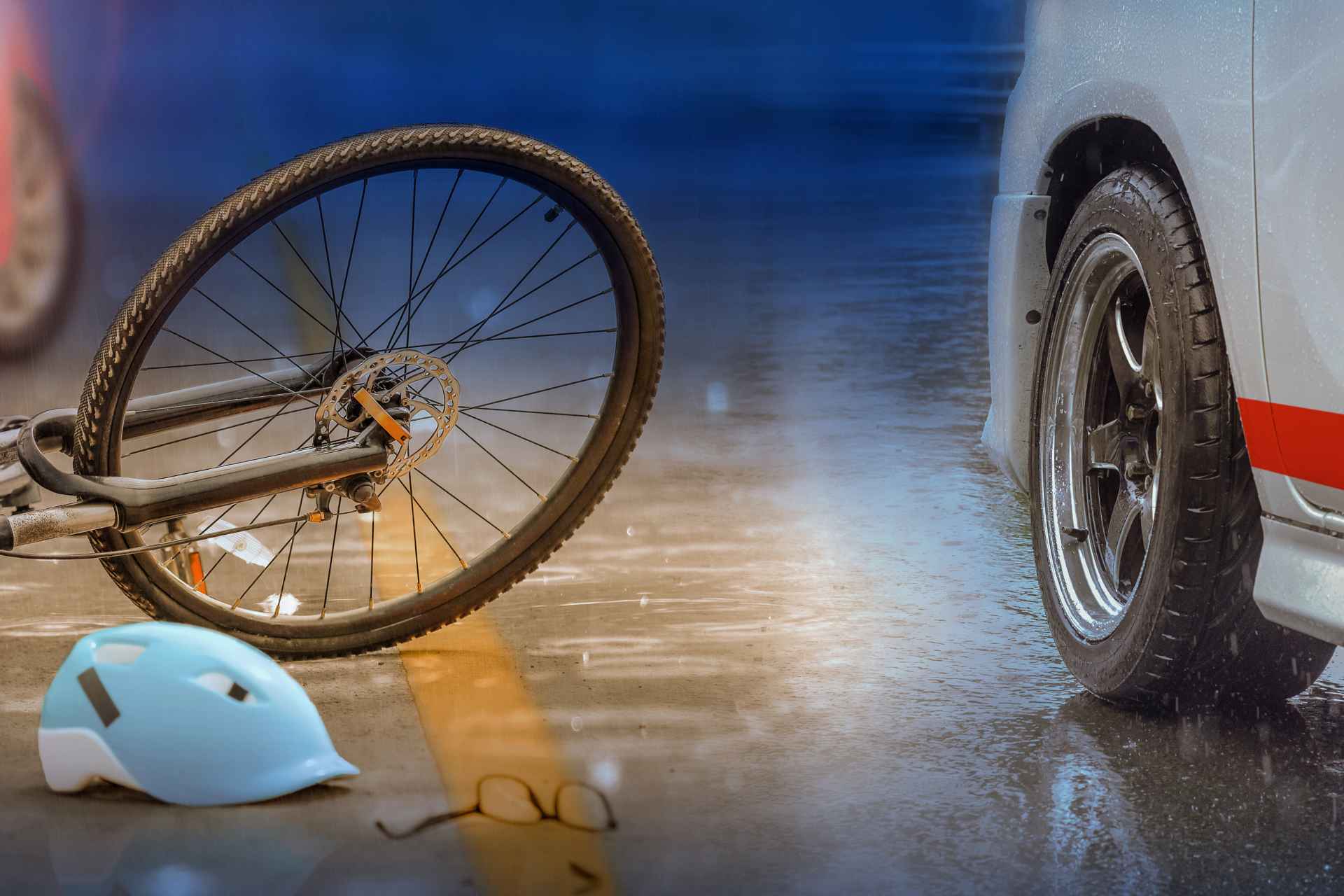 An ambulance assists a person who was involved in a bicycle accident.