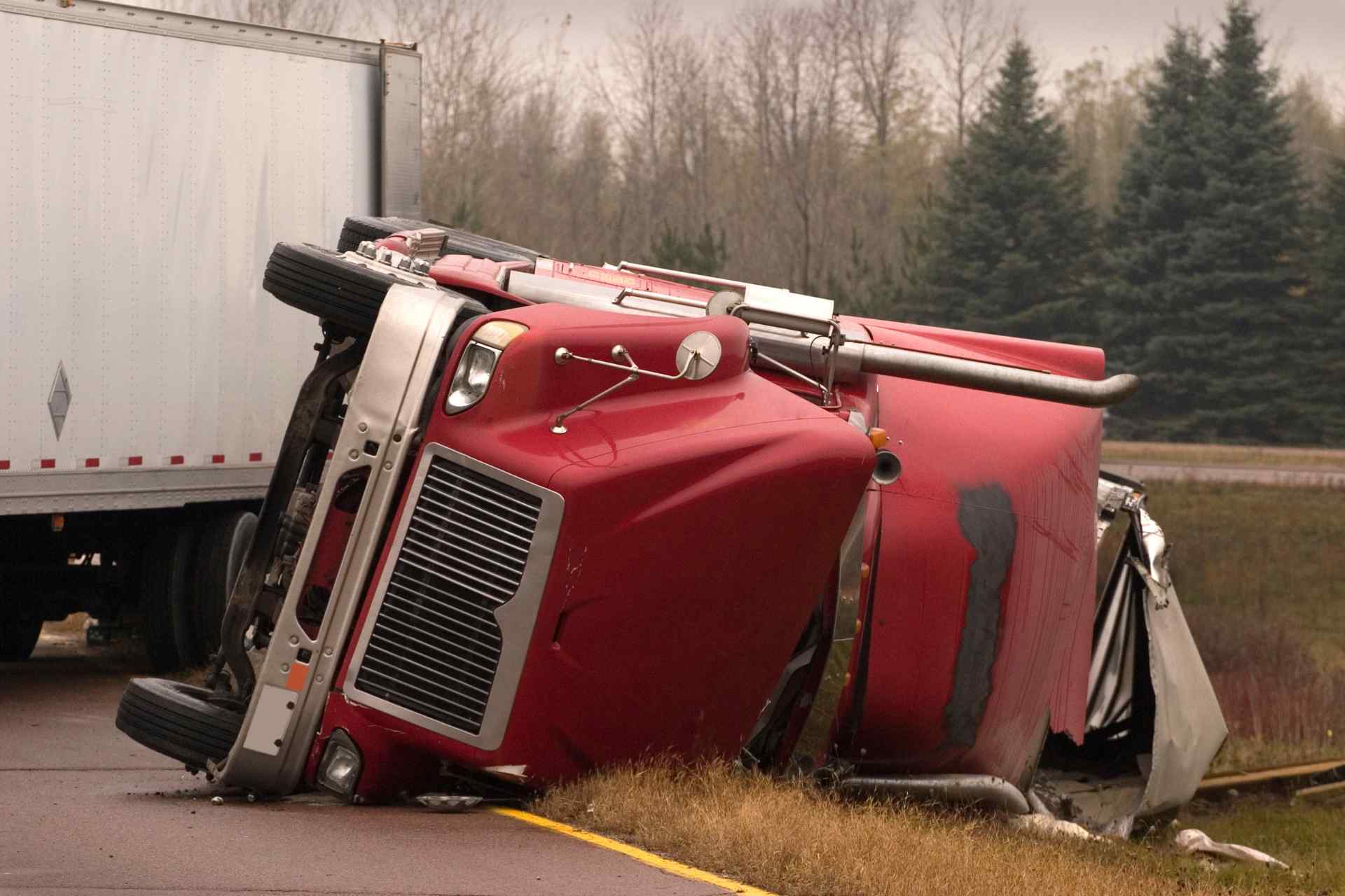 A truck overturned on the road after having an accident.