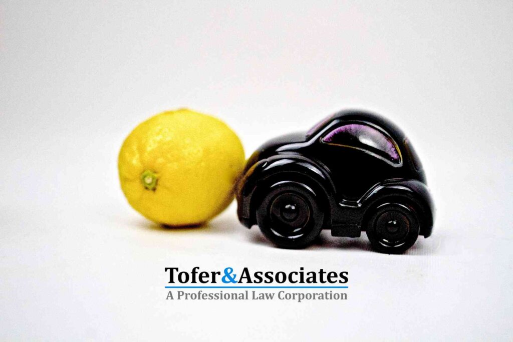 A lemon and a toy car in symbolizing a lemon car legal issue.