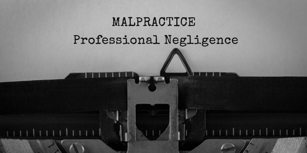 "Close-up of a typewriter with the words 'MALPRACTICE Professional Negligence' typed on paper, symbolizing legal issues related to professional negligence