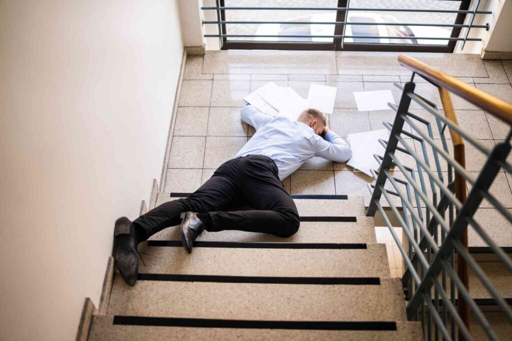 Man injured in a slip and fall accident on stairs, representing premises liability case