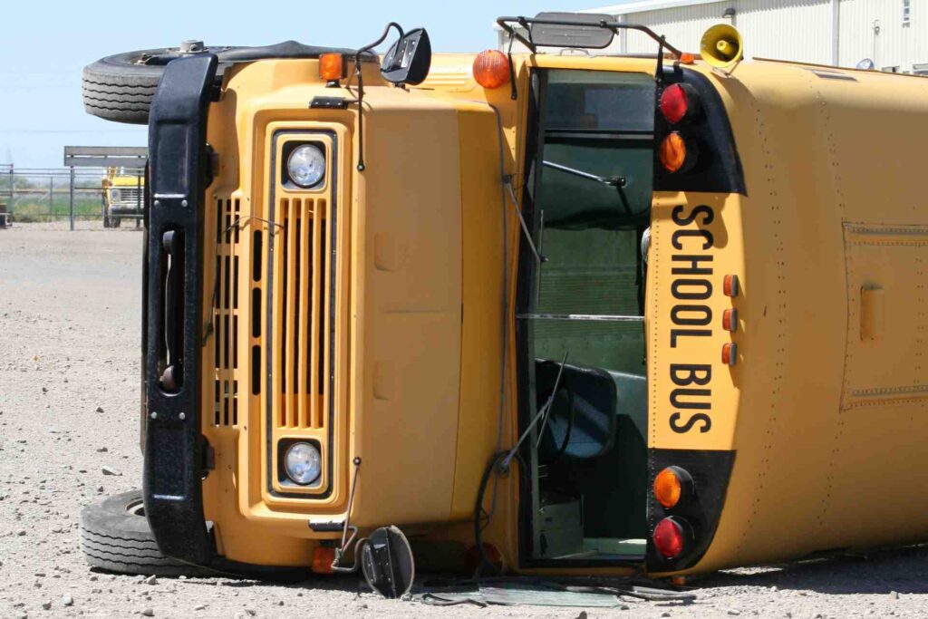 Overturned school bus on the ground after an accident