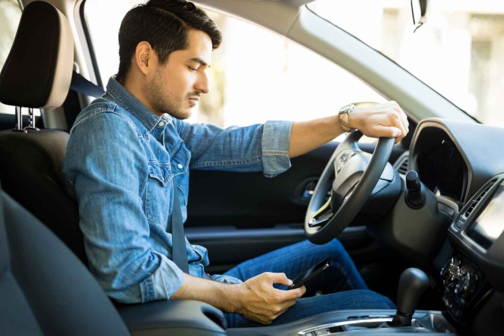A man texting while driving in California